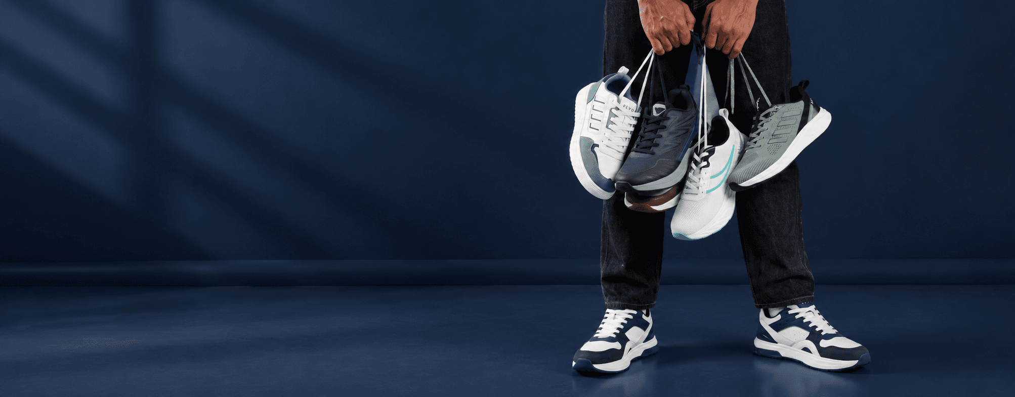 Flyo sports shoes held by their laces