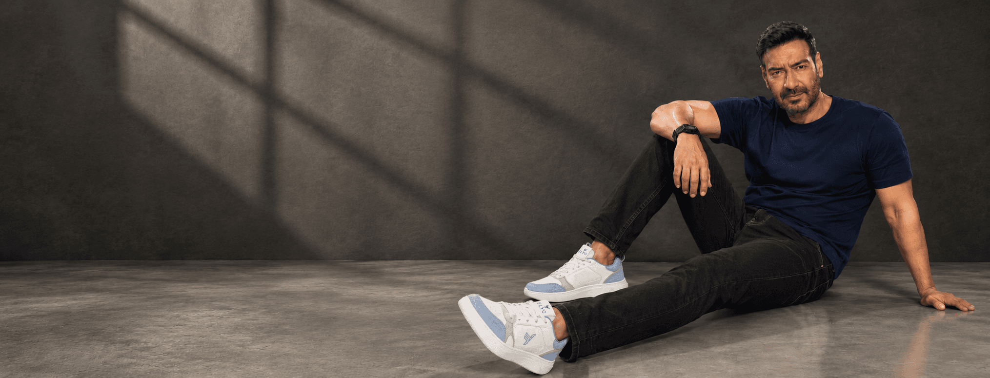 Flyo brand ambassador wearing white and blue Flyo sneakers